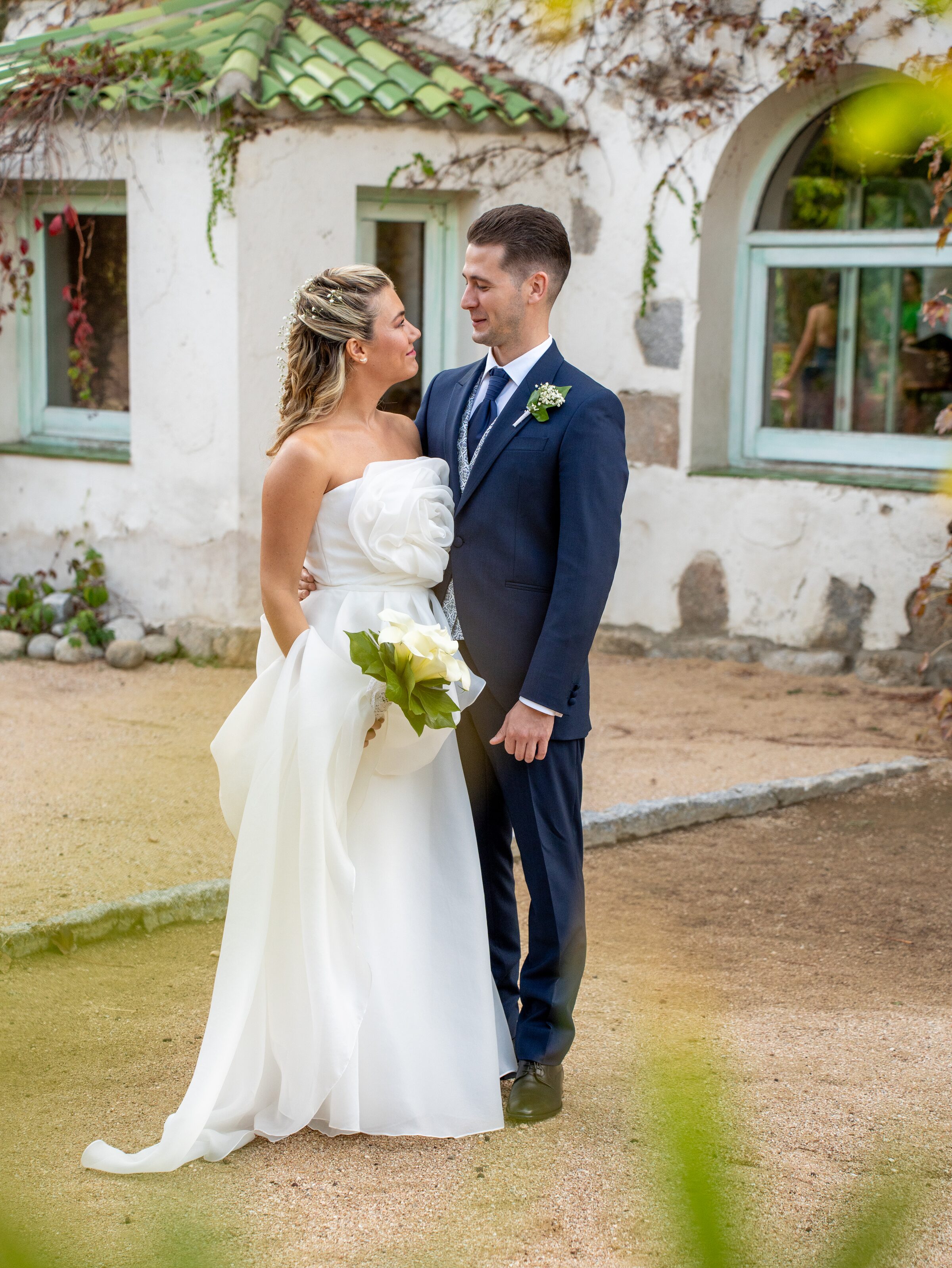 Pareja delante de casa rural blanca